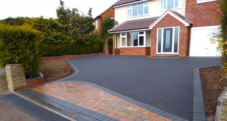 Finished tarmac driveway with a contrasting block paved entrance